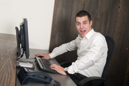 Male working at a computer in an officeの写真素材
