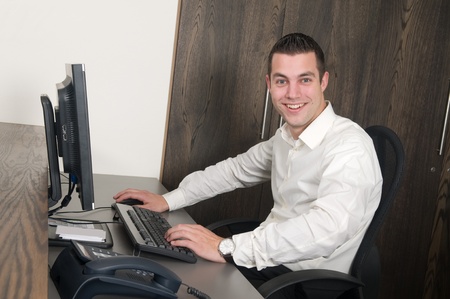 Male working at a computer in an officeの写真素材