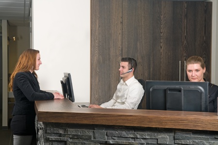 Customer getting some information at a service deskの写真素材