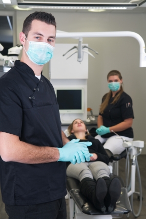 Dentist in the front, nurse and patient in the backgroundの写真素材