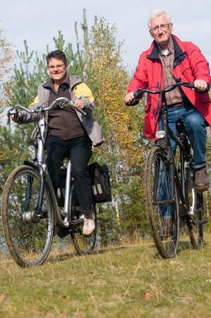 Two seniors on a bicycle trip during summerの写真素材
