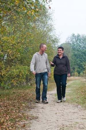 Man and a woman having a walk in the forest.の写真素材