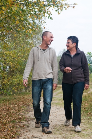 Man and a woman having a walk in the forest.の写真素材