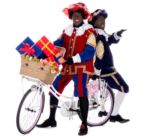Zwarte piet is going to bring the presents to the childrenの写真素材