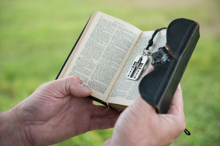 Man reading a bible outsideの写真素材