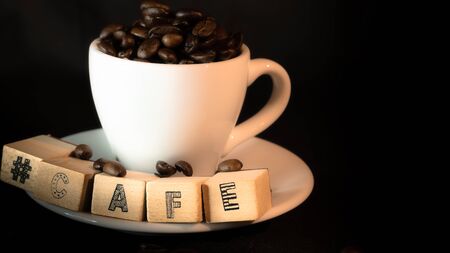 Colombian coffee cup on beans and dark backgroundの写真素材