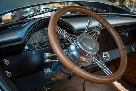 Steering wheel of a classic car, with wood finish and elegant metallic details, sophistication and...