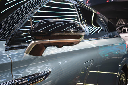 Detail of the exterior side mirror with LED turn signal repeater, glossy black finish, and metallic...
