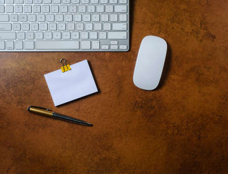 Office table with notepad, computer keyboard, mouse and pen. View from above.の写真素材