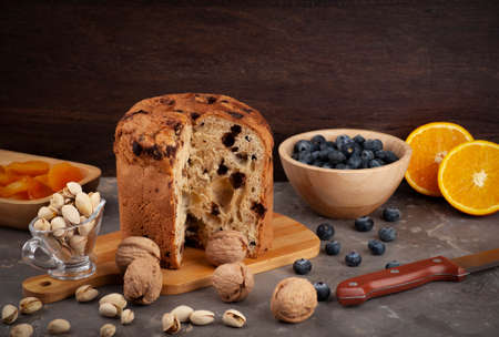 panettone on a kitchen board and side dishes arranged at random, selective focus and copy space.の写真素材