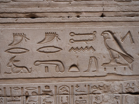 Egyptian hieroglyphic engravings on the stone walls of the temple of the God Horus in Edfu Egypt