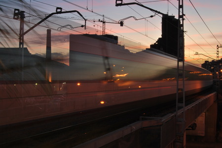 BARCELONA, SPAIN - NOVEMBER 2017: Regional train fading away passing through Hospitalet reflecting...