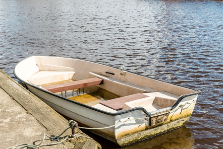 an old rowing boat in the waterの写真素材