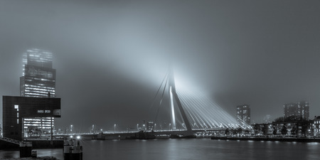 View on the Erasmusbridge from the Stieltjesstraas by night and fog in black and whiteのeditorial素材