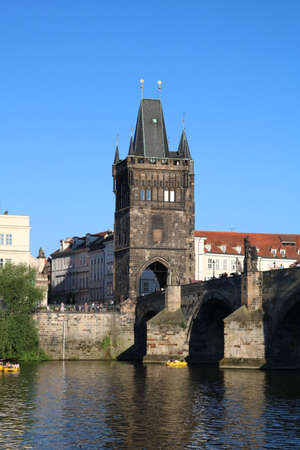 The majestic Charles Bridge over the serene Vltava River on a clear sunny dayのeditorial素材
