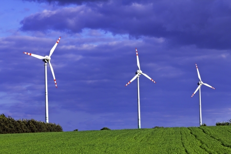 Three windmills before stormy weatherの写真素材