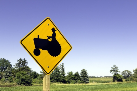 Farm tractor sign against blue skyの写真素材