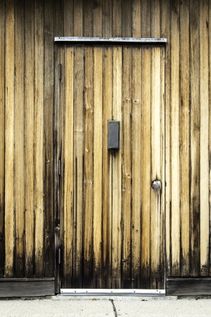 Aged wooden door with vertical post boxの写真素材