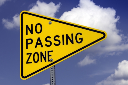 No passing road sign against blue skyの写真素材