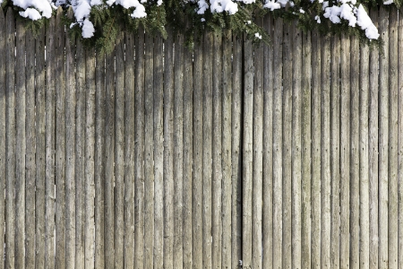 Wooden fence with snow on the topの写真素材