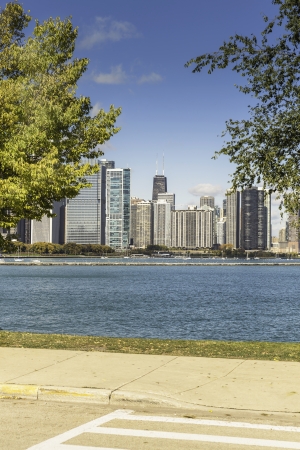 Pavement with grass and Chicago downtown as background on sunny fall day - warm colorの写真素材