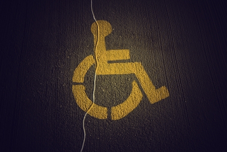 Disabled icon on broken asphalt backgroundの写真素材