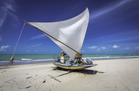 Small fishing boat on the beach of Natal, Brazilの写真素材