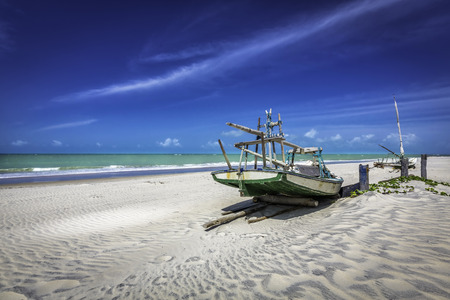 Small fishing boat on the beach of Natal, Brazilの写真素材