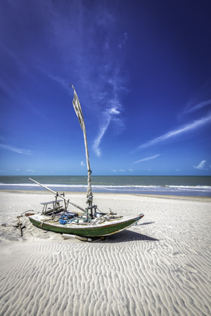 Small fishing boat on the beach of Natal, Brazilの写真素材