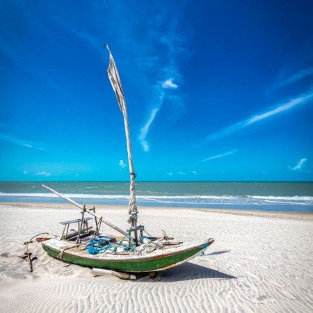 Small fishing boat on the beach of Natal, Brazilの写真素材