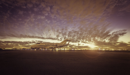 Plane at airport during sunset, light leaks