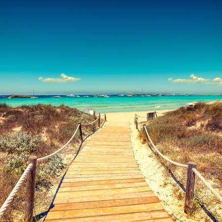 Entrance to the beach with wooden walkway in tropical islandの写真素材