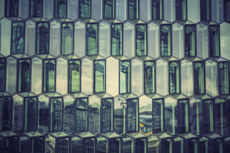 Glass facade with reflection of abstract buildingの写真素材