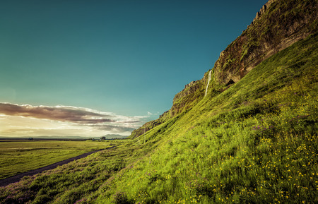Sunset over Seljalandsfoss Waterfall in Icelandの写真素材