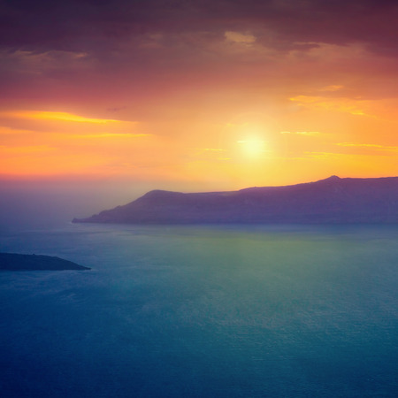 Famous sunset above Caldera view over sea in Santorini Island, Greeceの写真素材