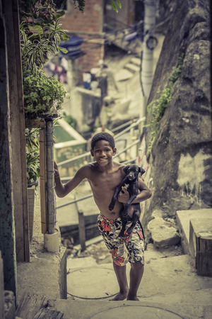 Boy wit a dog in Favela (slums) in Rio de Janeiroのeditorial素材