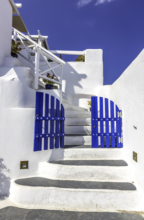 Blue gates with white stairs as welcome sign- beautiful details of Santorini Island, Greeceの写真素材