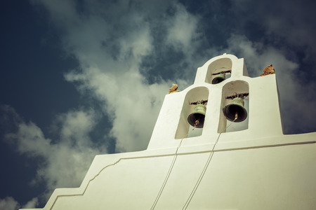 Belfry structure with green bells on Santorini Island, Greeceの写真素材