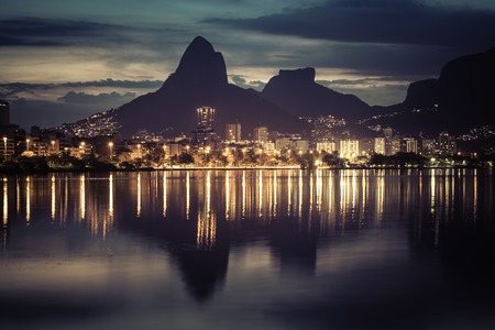 Sunset behind mountains in Rio de Janeiro with water reflection, Brazilの写真素材