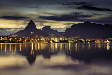 Sunset behind mountains in Rio de Janeiro with water reflection, Brazilの写真素材