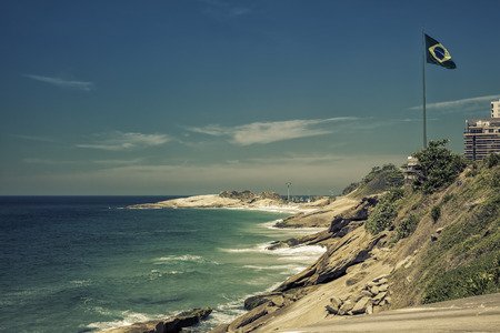 Brazilian flag waving on wind by the beach, Rio de Janeiro