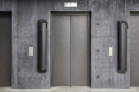 Metal elevator doors in a minimalistic style interior lobbyの写真素材