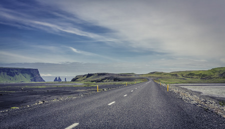 Curved asphalt road in mountains of Icelandの写真素材