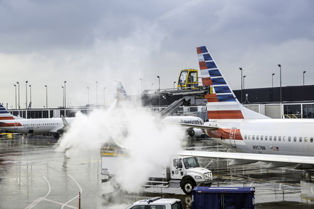 CHICAGO,UNITED STATES - JANUARY 22: Deicing of the American Airlines planes before take off on January 22, 2016 in Chicago. Deicing on O'Hare International Airport due to cold and snowy conditions.のeditorial素材