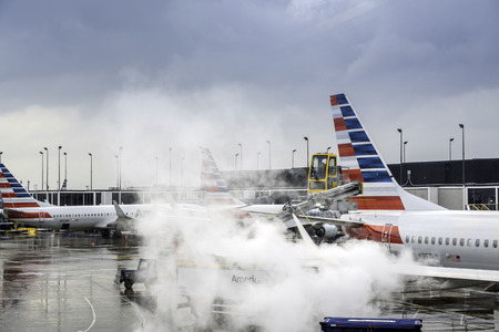 CHICAGO,UNITED STATES - JANUARY 22: Deicing of the American Airlines planes before take off on January 22, 2016 in Chicago. Deicing on O'Hare International Airport due to cold and snowy conditions.のeditorial素材