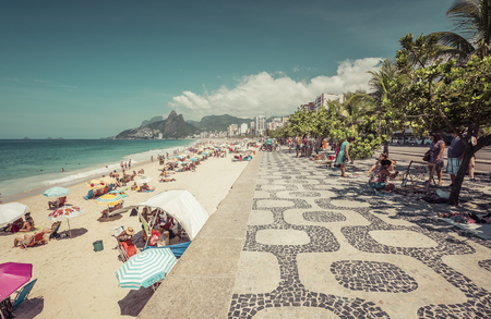 People enjoying the sun on iconic Ipanema Beach in Rio de Janeiro.のeditorial素材