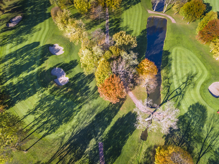 Aerial above Golf Course, fall season, colorful treesの写真素材