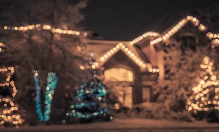 Seasonal Christmas House Lights Decoration, outdoor blurred defocused view. Xmas showcaseの写真素材