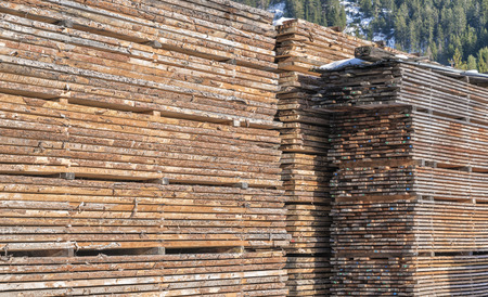 Drying timber boards at the sawmill in winter Alp Mountainsの写真素材