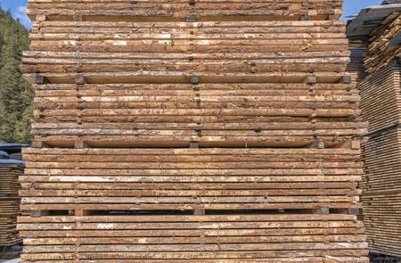 Drying timber boards at the sawmill in winter Alp Mountainsの写真素材